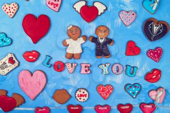 Gingerbreads for Valentines Day or Marriage on blue concrete background