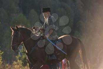 CHARISHSKOE. ALTAISKIY KRAI. WESTERN SIBERIA. RUSSIA - SEPTEMBER 15, 2016: descendants of the Cossacks in the Altai, cossack rides a horse, with a saber at the festival on September 15, 2016 in Altayskiy krai, Siberia, Russia.