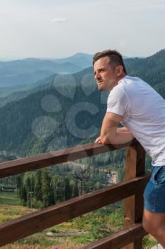 Man standing and looking into the distance in mountains