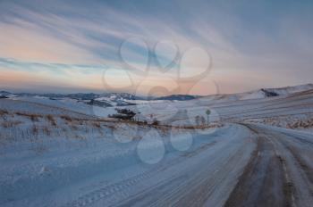 Altai mountains winter road through mountains pass. Early morning before sunrise