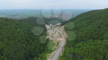 Aerial 4k drone video of top vew of winding road in the mountains, Altai Krai, Western Siberia, Russia. Road to Resort town Belokurikha 2