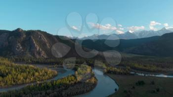 Kurai steppe and Chuya river on North-Chui ridge mountains background. Altai mountains, Russia. Aerial drone 4k video.