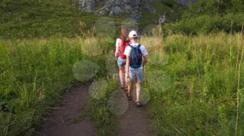 Mother and her son walking in the Altai mountains gorge
