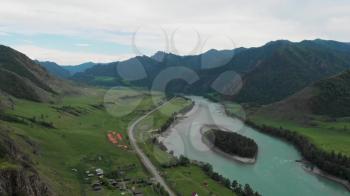 Mountain river Katun and green egg shaped island into the river, green valley, beauty summer evening, Altai mountains