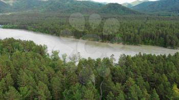 Aerial view of Katun river, in Altai mountains, in beauty summer evening, the boat floats on the river, cinematic drone footage