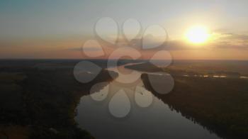Aerial view of big siberian Ob river with boat in beauty summer sunset, 4K drone footage.