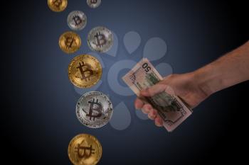 Hand holding dollar money and bitcoin on blue dark background. New virtual money or buying crypto currency concept