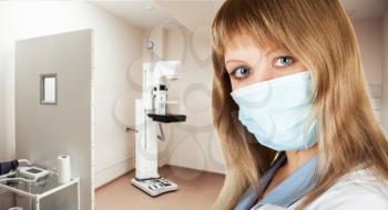 Female doctor mammologist or radiologist working in the room with equipment for breast x-ray