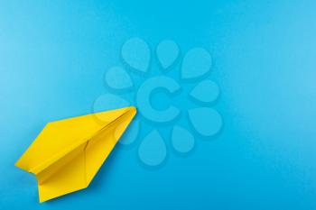Flat lay of color paper plane on blue color paper background. Business for innovative solutionor air travel concept