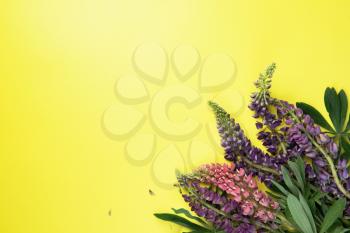 Yellow paper mockup for text with decor made of flower lupine