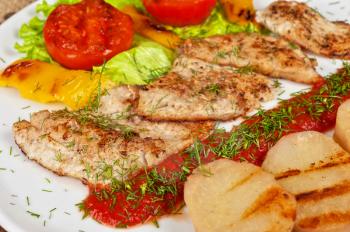 Tasty fish pike perch fillet with vegetables and sauce