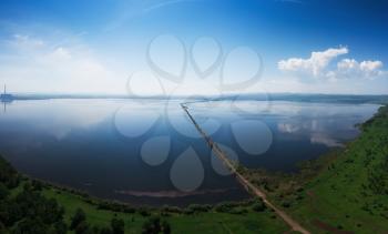 Beryozovskoye reservoir - cooling reservoir of Beryozovskaya GRES. Aerial drone view of lake landscape with road in sunny summer. Berezovskaya GRES is a thermal power plant in the town of Sharypovo, Krasnoyarsk Territory of Russia.