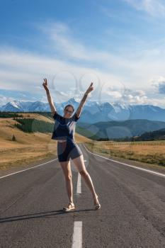 Woman om the Chuysky trakt road in the Altai mountains. One of the most beautiful road in the world.