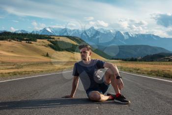 Man on the Chuysky trakt road in the Altai mountains. One of the most beautiful road in the world.