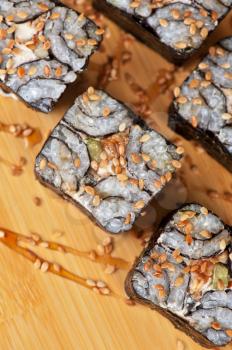Japanese cuisine - sesame sushi rolls with syrup