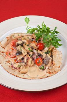 pancake with peled fish, different vegetables and sauce