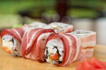 Japanese cuisine - sushi roll with bacon