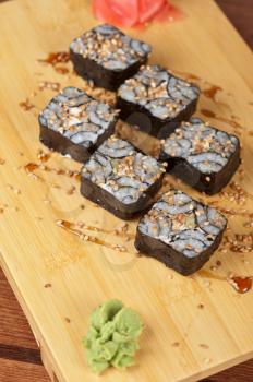 Japanese cuisine - sesame sushi rolls with syrup