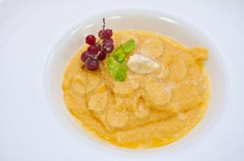 Corn porridge with berry closeup