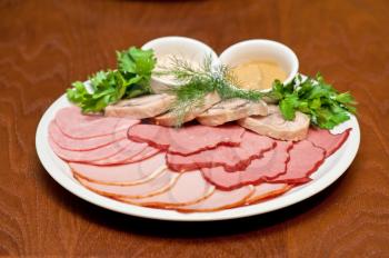 Group of thin sliced meat, ham and sauce