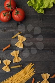 food background on rustic wood with pasta and tomatoes