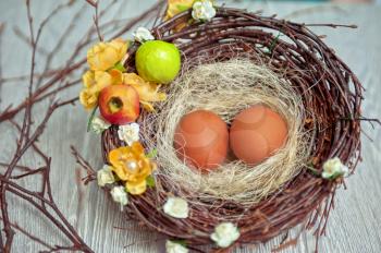 eggs in nest on a wooden background for easter