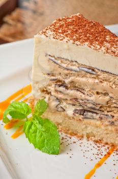 Italian dessert. Cake from ice cream mascarpone cheese chocolate. Decorated with mango sauce.