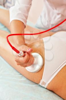 Defocused pronounced background of procedure for women hip against cellulite and fat