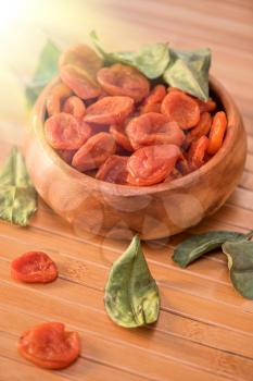 Dried apricots in a wooden bowl
