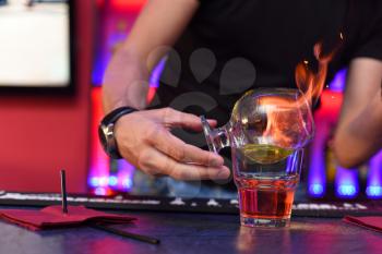 Closeup photo in a bar where barmen makes cocktail