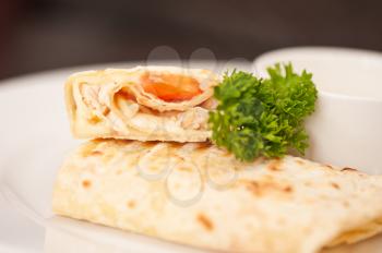 tortilla with chicken breast tomato and cheese served with sour cream
