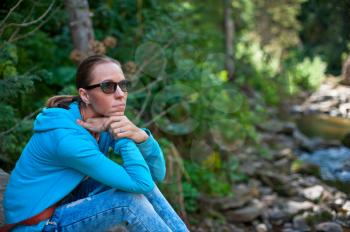 Portrait of attractive woman sitting in forest