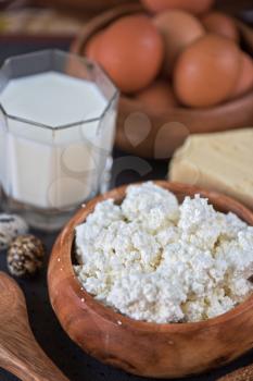 still life with dairy products as milk, cheese cottage cheese eggs and bread 
