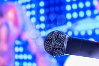 Closeup of audio microphone on stage background