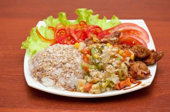plate of chinese rice with roasted meat and vegetables