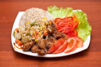 plate of chinese rice with roasted meat and vegetables