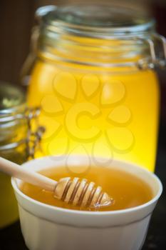 Honey with wooden spoon closeup photo