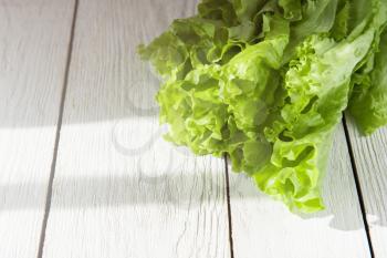 lettuce salad on a white wood background