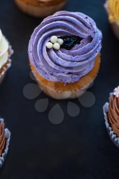 Cupcakes desert cream with space on a stone background