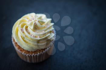 Cupcake desert cream with space for text on a stone background