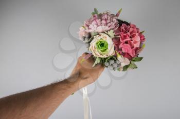 male hand giving wedding bouquet, first-person view