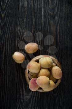 orange fresh apricots on a wooden background
