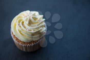 Cupcakes desert cream with space for text on a stone background