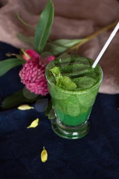 Healthy organic green smoothie with basil mint and lemon