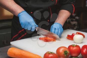 Chef cutting vegetables with knife