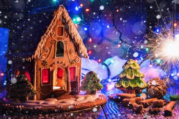 Gingerbread house with lights on dark background, xmas theme