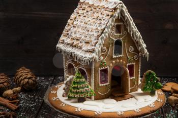 Homemade gingerbread house on dark background, xmas theme