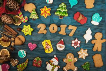 Gingerbreads for new 2017 year holiday on wooden background, xmas theme