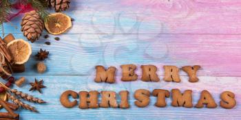 Different ginger cookies for new years and christmas on wooden background, top view with space for design