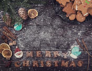 Gingerbreads for new years and christmas on wooden background with space for design